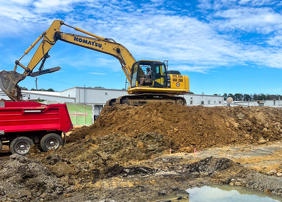 A heavy equipment operator from East Coast Civil Group does excavation work with a Komatsu hydraulic excavator. The excavation job site is near Raleigh, NC.