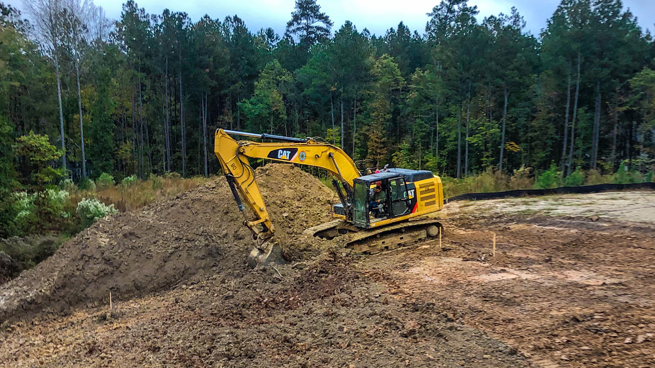 An East Coast Civil Group heavy equipment operator uses a hydraulic excavator during a lot remediation job near Raleigh, NC